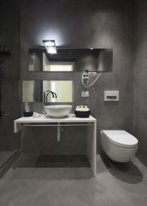 a bathroom with a sink and a toilet at Como Luxury Rooms in Como +33 photos