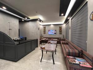 a restaurant with tables and a counter in a room at Sandra Hotel in Amman +28 photos