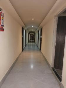 an empty corridor in a building with a long hallway at Collection O 81233 Mr Residency in Hyderabad