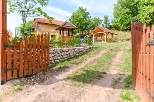a wooden fence in front of a house at Green House Latin Grad in Vrmdža