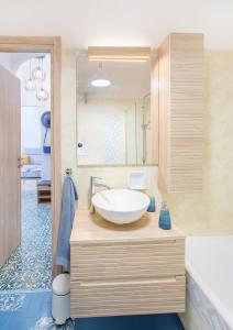 a bathroom with a sink and a bath tub at Dipinto di Blu by PortofinoVacanze in Rapallo