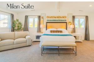 a bedroom with a large bed and a couch at Villa Inn- Adults Only- Temecula Wine Country in Temecula