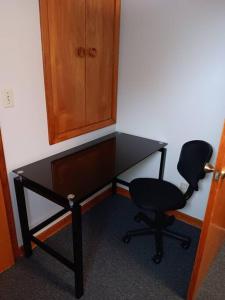 a desk with a chair and a cabinet at private upper 1 bd apartment in Buffalo