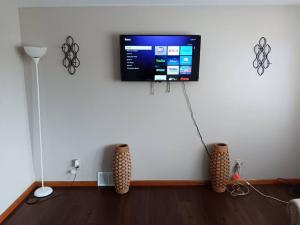 a living room with a flat screen tv on a wall at private upper 1 bd apartment in Buffalo