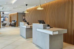 an office with two reception desks and a wooden wall at Courtyard by Marriott Oxford City Centre in Oxford
