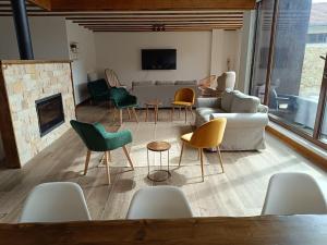 a living room with a couch and chairs and a fireplace at MIRADOR DEL HITO I y MIRADOR DEL HITO II in Espinosa de Bricia