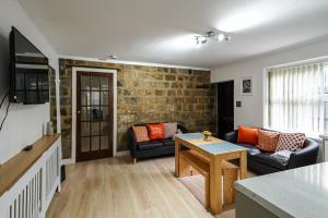 uma sala de estar com um sofá e uma mesa em Headingley 2 Bedroom cottage flat Near Universities shops& Park em Leeds