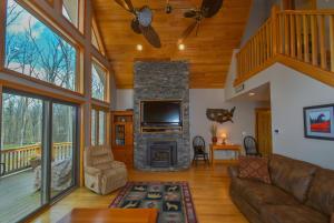 a living room with a fireplace and a tv at Keep Calm and Lake On in Swanton