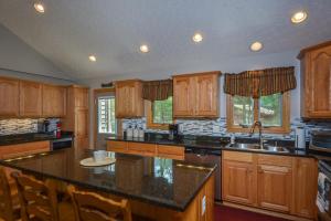 a kitchen with wooden cabinets and a counter top at Keep Calm and Lake On in Swanton