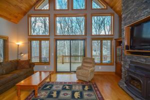 a living room with a fireplace and a tv at Keep Calm and Lake On in Swanton +34 photos