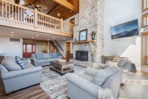 a living room with couches and a stone fireplace at Under the Stars in Oakland