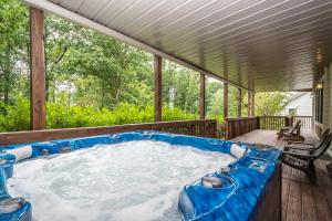 a hot tub on the deck of a house at Stilwater Serenity in Swanton