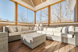 a large living room with a couch and windows at Stilwater Serenity in Swanton +59 photos