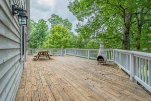 a wooden deck with a grill on the side of a house at Fore Seasons Getaway in McHenry