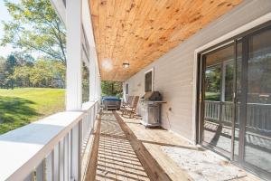 a porch of a house with a wooden ceiling at Fore Seasons Getaway in McHenry