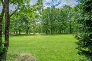 a large field of grass with trees in the background at Fore Seasons Getaway in McHenry +83 photos