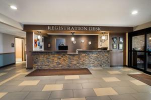 a restaurant lobby with a sign that reads registration desk at Best Western Park Oasis Inn in Mauston