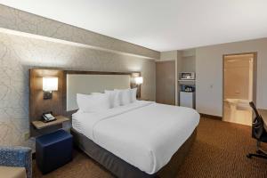 a hotel room with a large bed and a bathroom at Best Western Halton Hills in Georgetown
