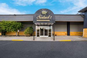 a front entrance to a restaurant with a sign on it at Richland Riverfront Hotel, Ascend Hotel Collection in Richland