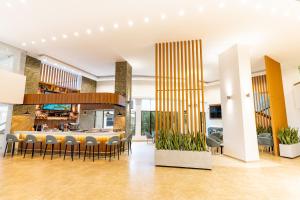 a lobby with a bar with chairs and a kitchen at Hotel Casino Internacional in Cúcuta