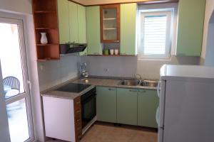 Kuchyň nebo kuchyňský kout v ubytování Apartment Basioli