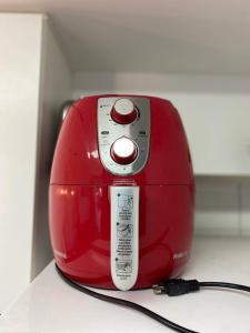 a red toaster sitting on top of a counter at Cupe Beach Living - Royal 206 in Porto De Galinhas
