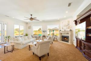 a living room with white furniture and a fireplace at Gaia Inn & Spa- Adults Only- Temecula Wine Country in Temecula