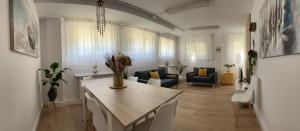 a living room with a table and a living room with a couch at RESISANTANDER - Apartamento para 9 personas in Santander