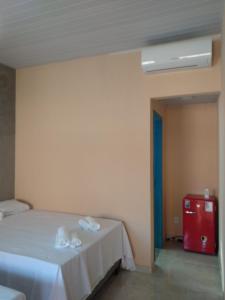 - une chambre avec un lit et des serviettes dans l'établissement Pousada Pérola do Rio, à Barreirinhas