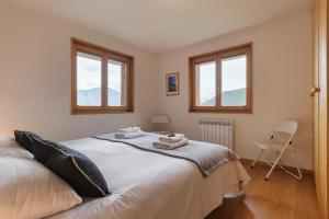 a bedroom with a bed with two towels on it at La Taniere - Cozy chalet with incredible views and parking in La Tzoumaz