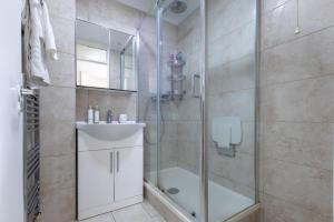 a bathroom with a shower and a sink at Beautiful House in London