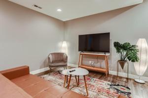 a living room with a couch and a flat screen tv at Central Park - 28th Place Apt in Aurora