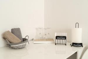 a white table with glasses and other items on it at Maison 31 in Santa Marinella