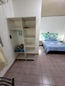 a room with two beds and a closet with a bed at GaVal Apart A in Posadas