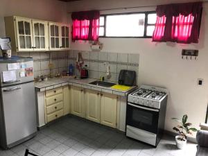a small kitchen with a stove and a refrigerator at GaVal Apart A in Posadas