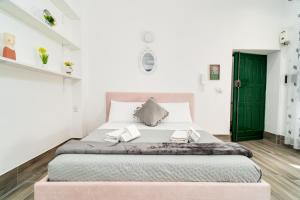 ein Schlafzimmer mit einem großen Bett und einer grünen Tür in der Unterkunft Maison 31 in Santa Marinella