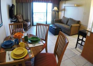 a living room with a table and chairs and a living room at Island Gulf Resort, a VRI resort in St. Pete Beach