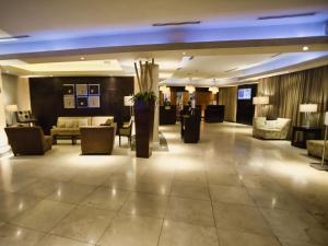 a hotel lobby with couches and chairs and a lobby at Hotel Lucerna Mexicali in Mexicali +62 photos