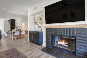 a living room with a fireplace with a tv above it at DL882 - Desert Falls Poolside Escape in Palm Desert