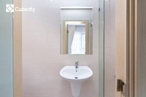 a bathroom with a sink and a mirror at Cubicity Hidden House in Ho Chi Minh City