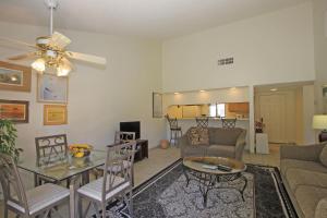 een woonkamer met een bank en een tafel bij P1807 - Costa Circle in Palm Desert