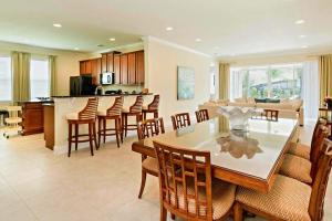 a kitchen and living room with a table and chairs at Deluxe Stay w Pool Spa Game Room BBQ Grill in Orlando