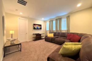 a living room with a couch and a table at Deluxe Stay w Pool Spa Game Room BBQ Grill in Orlando