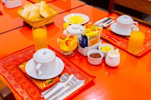 stół z talerzami, naczyniami i jedzeniem w obiekcie Hostal Samakuy AQP w mieście Arequipa
