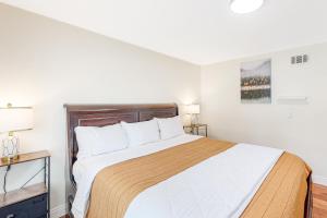 a bedroom with a large bed with a wooden headboard at Goleta Getaway in Santa Barbara