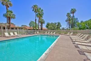 a swimming pool with lounge chairs and palm trees at PY732 - Champion Haven - Meredith Lodging in Palm Desert