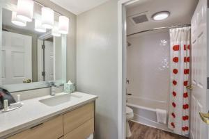 a bathroom with a sink and a toilet and a mirror at TownePlace Suites Tallahassee North/Capital Circle in Tallahassee