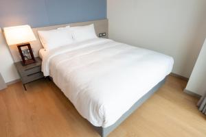 Posteľ alebo postele v izbe v ubytovaní Ramada Plaza by Wyndham Jaeun