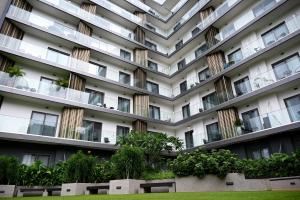an apartment building with windows and plants at The Eden Suite in Accra