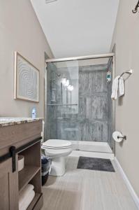 a bathroom with a toilet and a glass shower at Homestead Retreat in O'Fallon